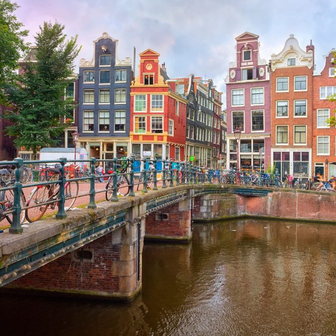 colorful buildings on canal with bicycles