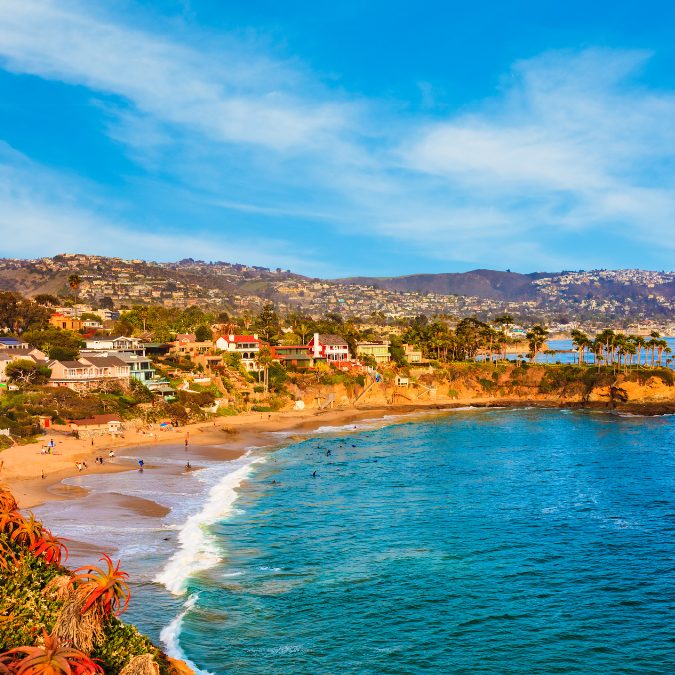 laguna beach coast with houses and beach,Best Warm Places To Visit In The USA (February)