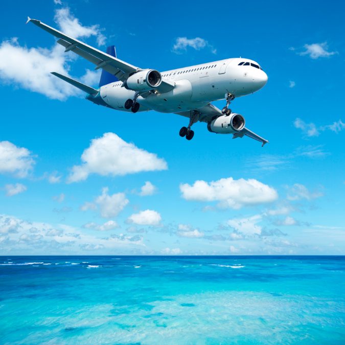 plane in sky flying over blue water how common are plane crashes