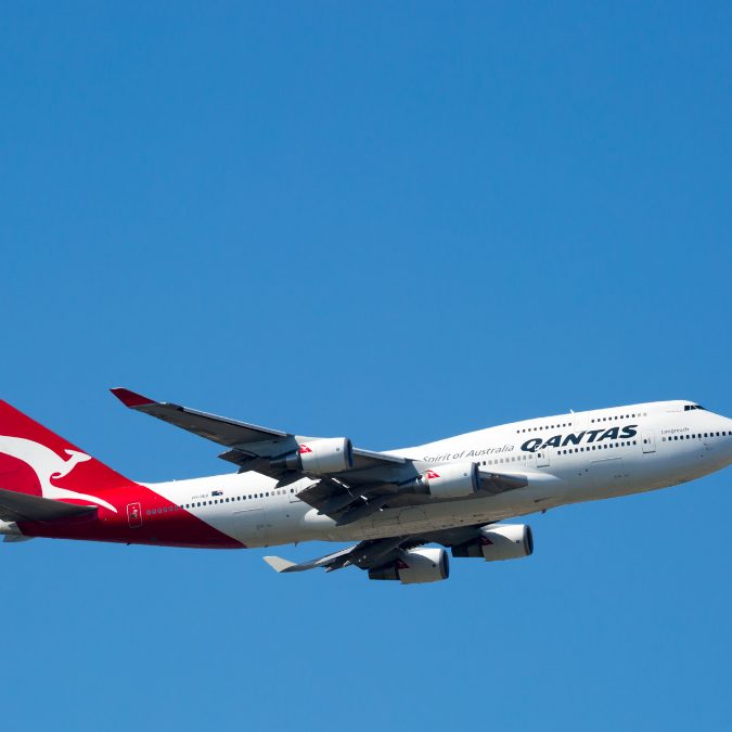 big white and red plane in the sky with qantas written on the side Best International Airlines To Fly To Europe