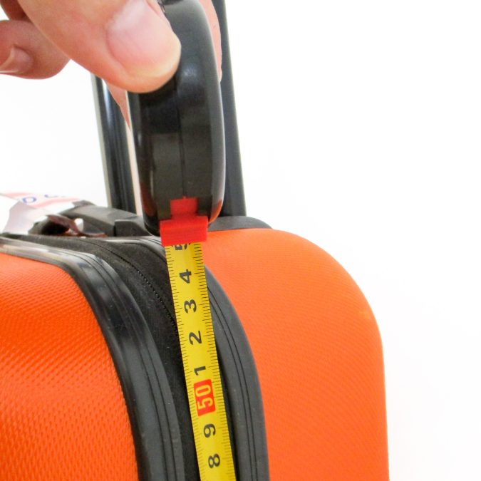 orange suitcase with yellow tape measure in cm 