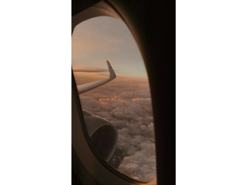 view of airplane wing with beautiful sunset in background
