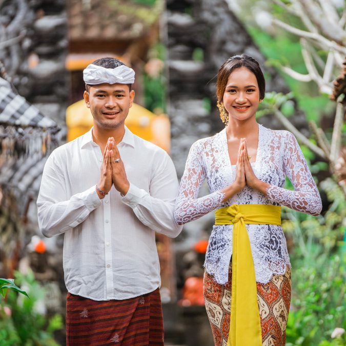 man and woman in bali with hands clasped 