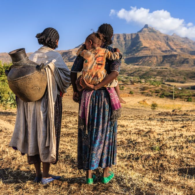 2 women walking in ethiopian landscape buying real estate property in Ethiopia