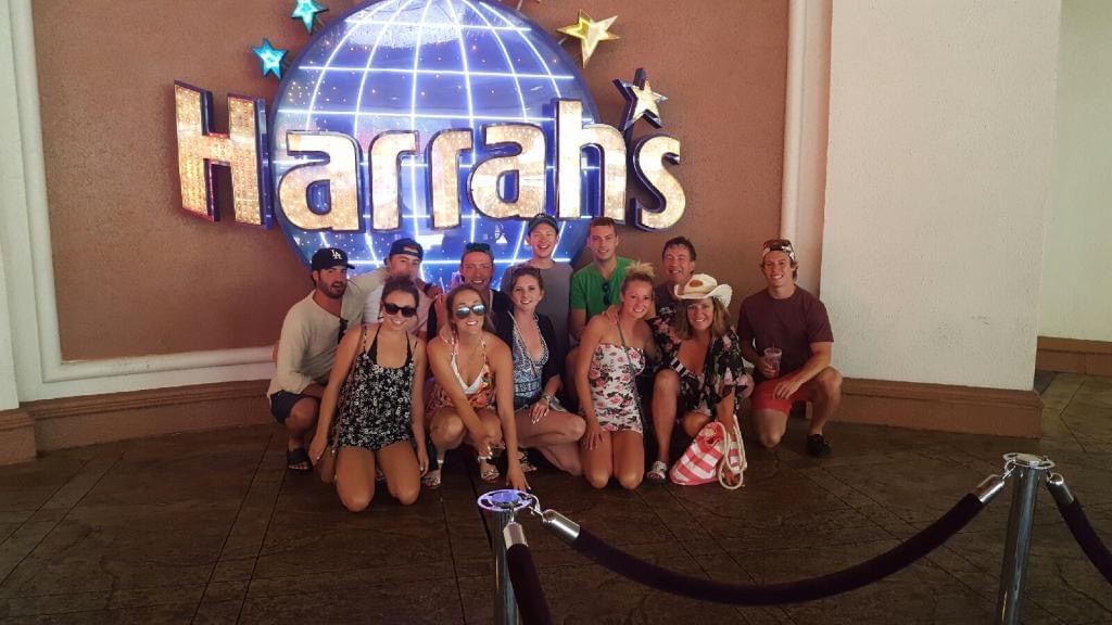 group of people in front of harrahs sign 