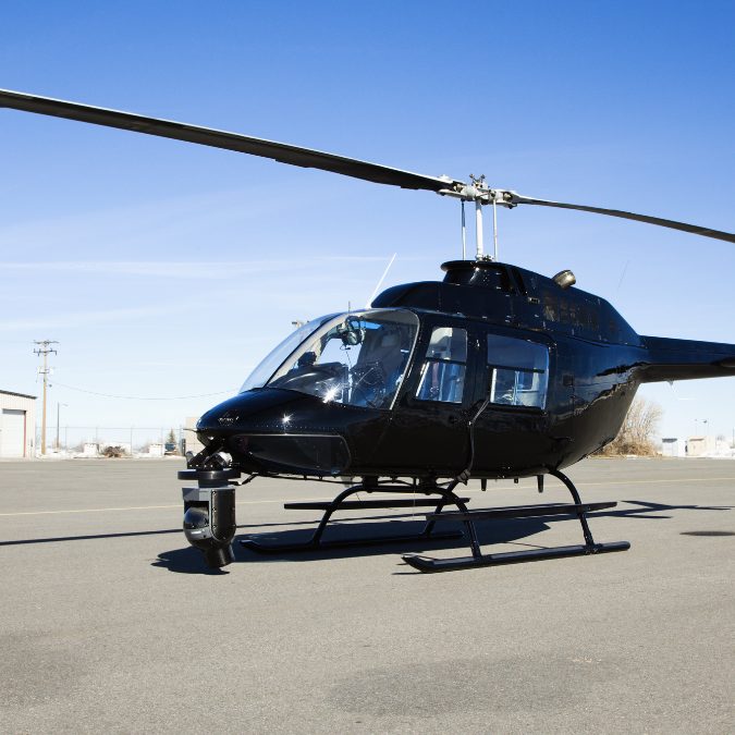 black helicopter with blue sky 
