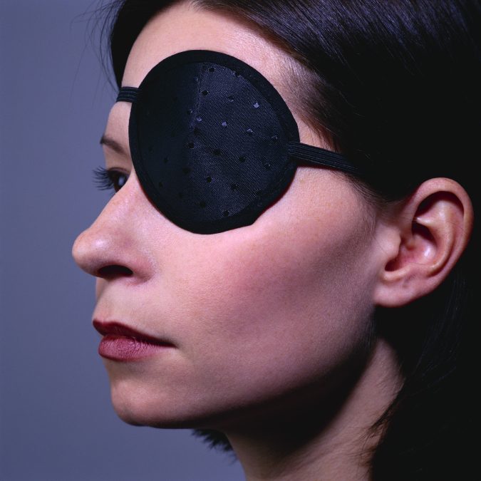 lady with eye patch on her eye fly after cataract surgery