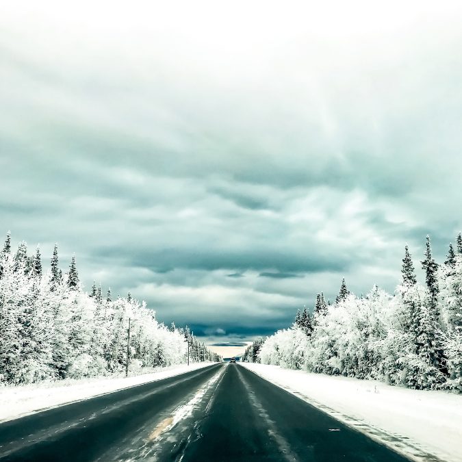 snowy straight road in alaska 