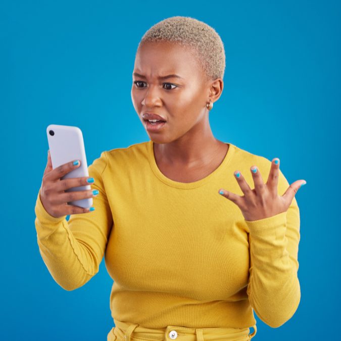 woman looking confused and angry at phone
