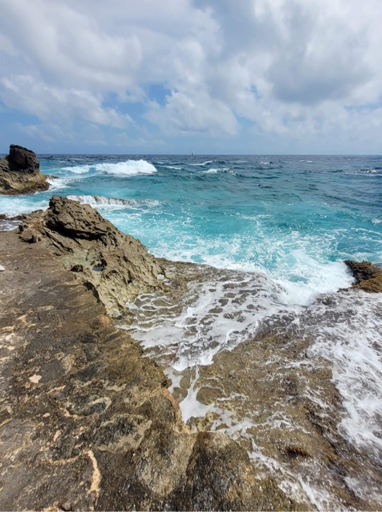 splashing ocean onto rocks in cancun Mexico