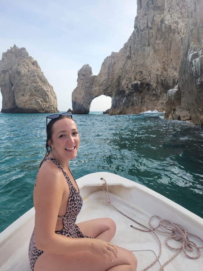 photo of girl in front of Cabo san lucas arc by the ocean water