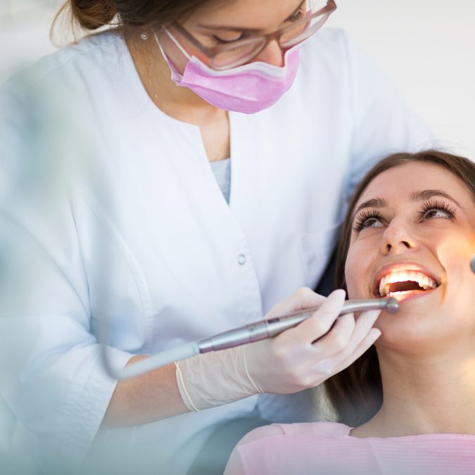 woman at dentist office smiling at dentist 