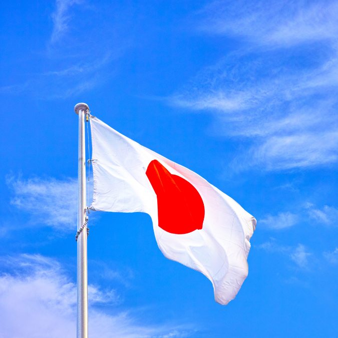 japanese flag blowing in the wind in the sky 