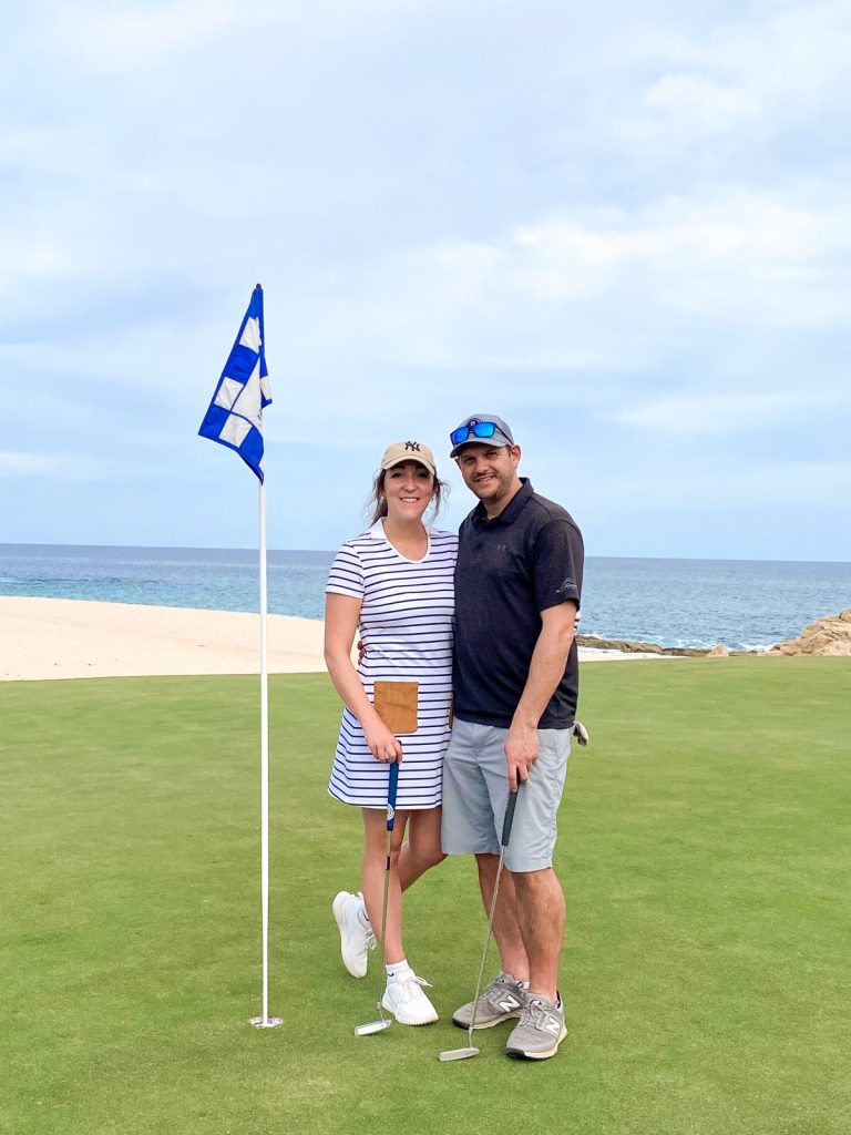 a couple standing near the flag at Pacific Ocean golf course