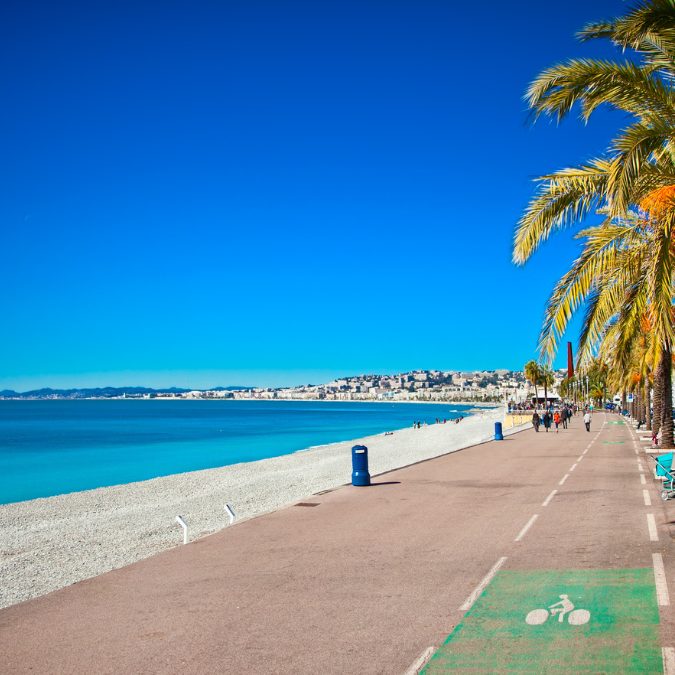 the promenade in nice france with blue waters