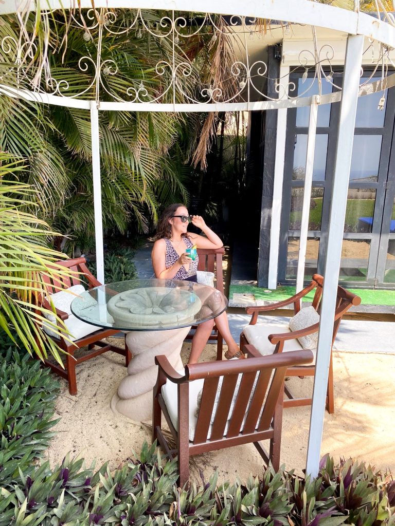 girl on patio in luxury home with a cocktail