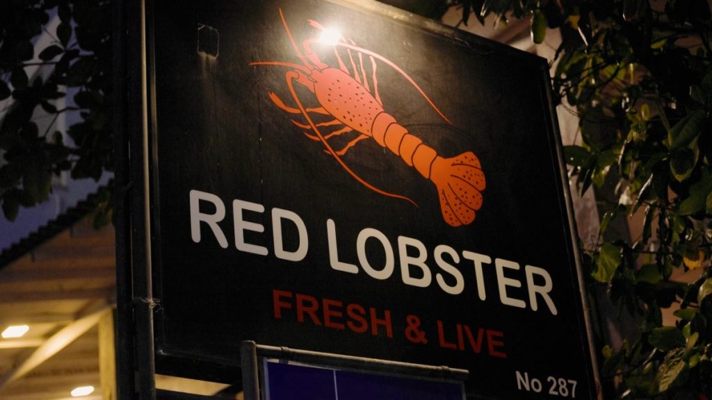 big sign with red lobster written on it in hikkaduwa sri lanka
