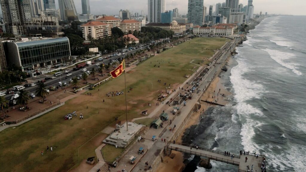 sri lankan flag with ocean and city 