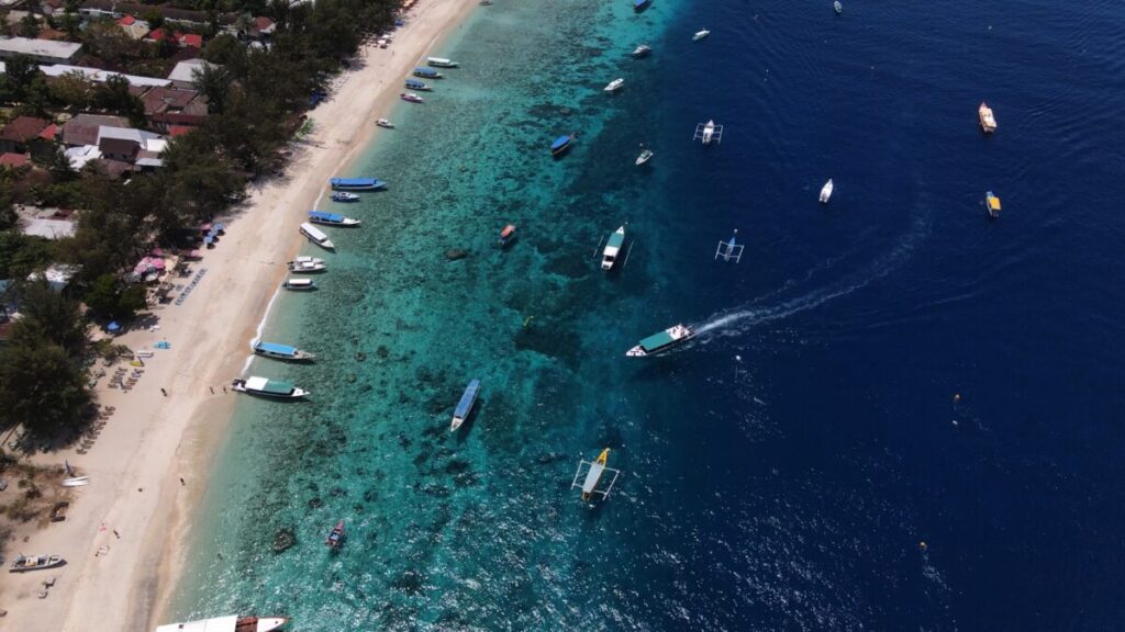 top down of crystal clear waters and white beach 